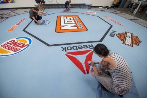 Camille Bohannon, bottom, makes finishing touches to a UFC mat at Larger Than Life, Inc. in Las Vegas on Wednesday, July 29, 2015. (Joshua Dahl/Las Vegas Review-Journal) 